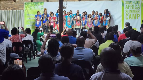 A choir on stage in front of an audience.